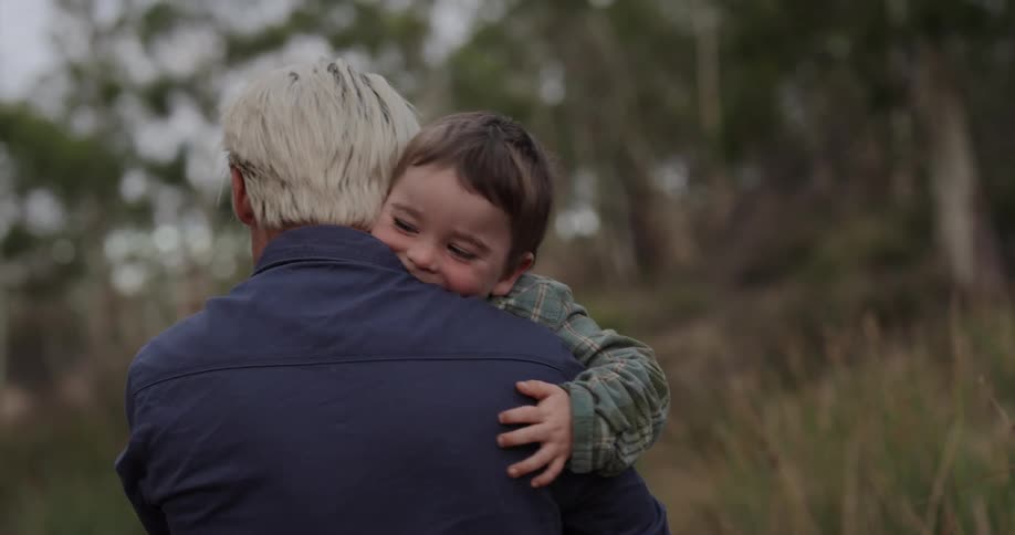 A father gives his son a big hug