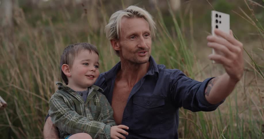 Father and son in a natural environment on a video call via smartphone