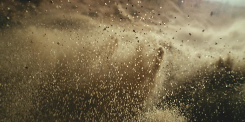 The sand jumps up and spreads around
