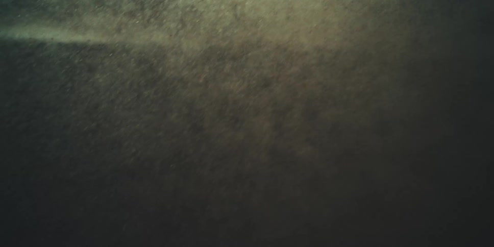 Grains of sand and other particles fly through the air during a cataclysmic storm