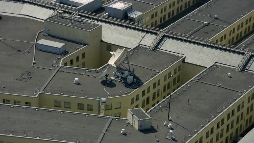 Large satellite sitting on the roof of a building