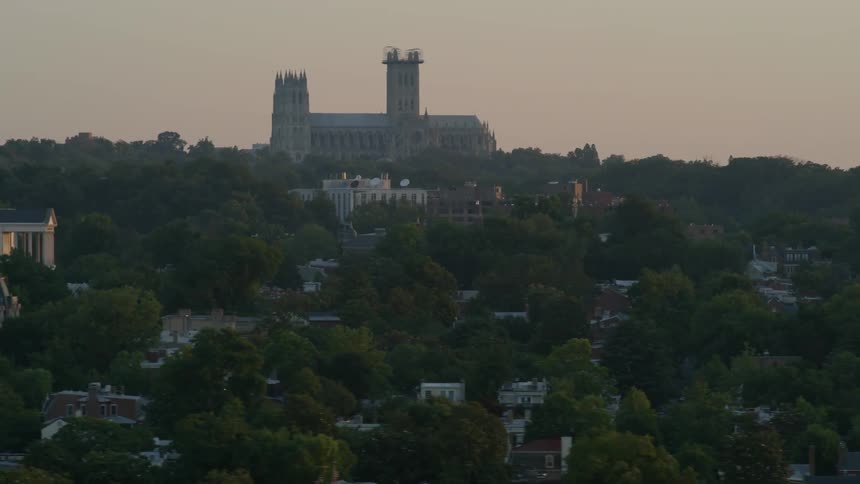 A wooded city at sunset
