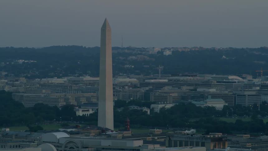 The washington monument stands against an overcast sky during the day