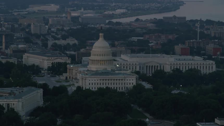 A capitol building stands in the distance