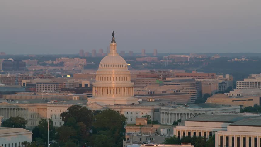 The sun is setting over a dome in this large city