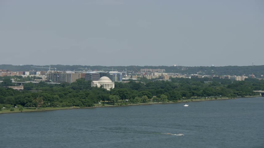 A boat is sailing in the water near this city