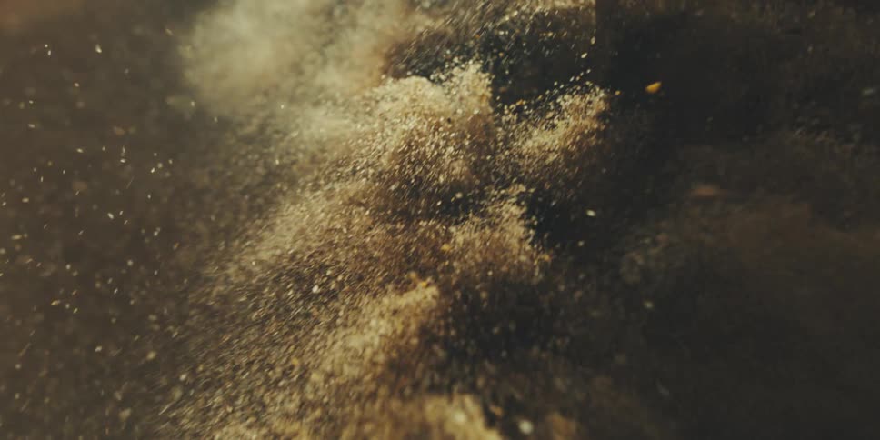 Clouds of dust and debris fly through the air during a cataclysm