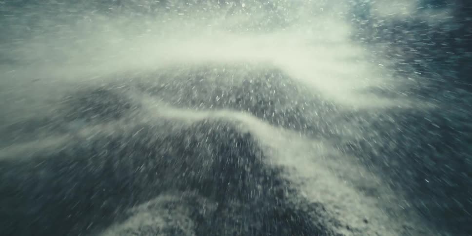 Gliding Over Silvery Dunes at Night as Particles Strike the Lens