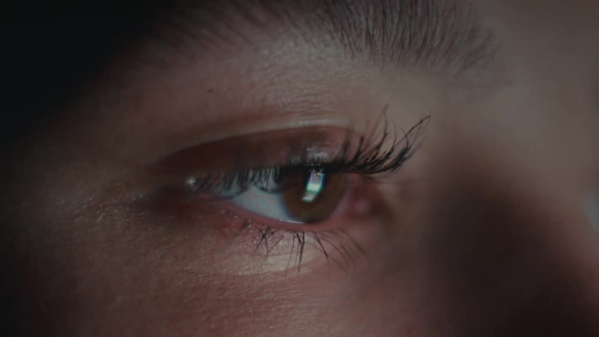 Light reflects on the womans eye