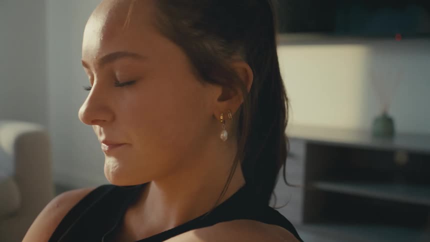 A woman closes her eyes and breathes deeply