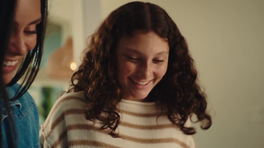 Women laugh together at something