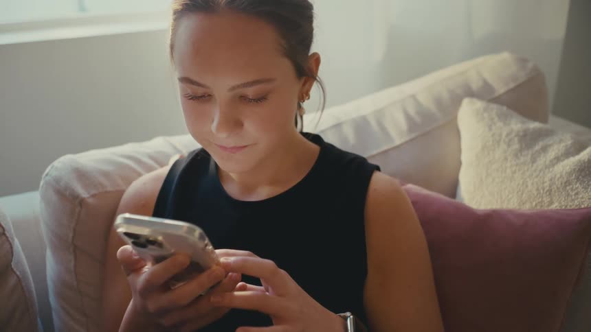 A woman is scrolling on her phone