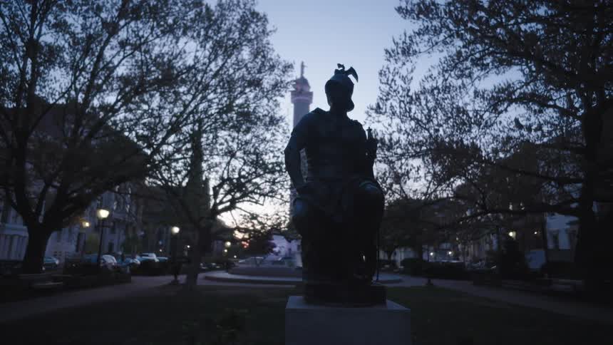 The sun is rising on the statue