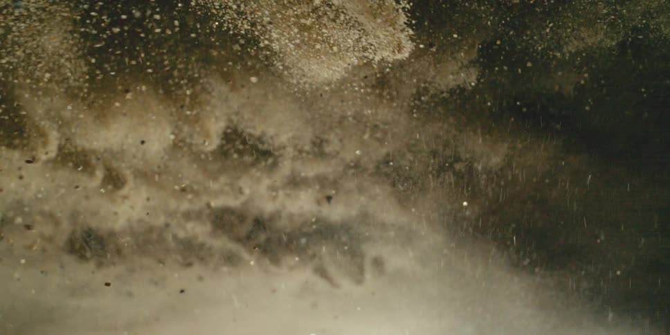Inverted Sea of Exploding Sand Waves and Flying Debris