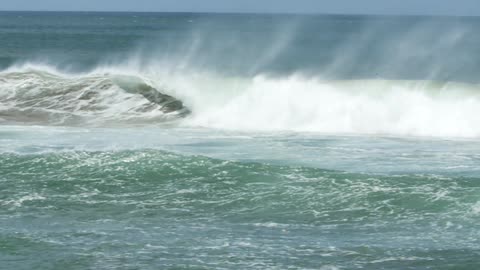 Ocean waves spraying water on a sunny day