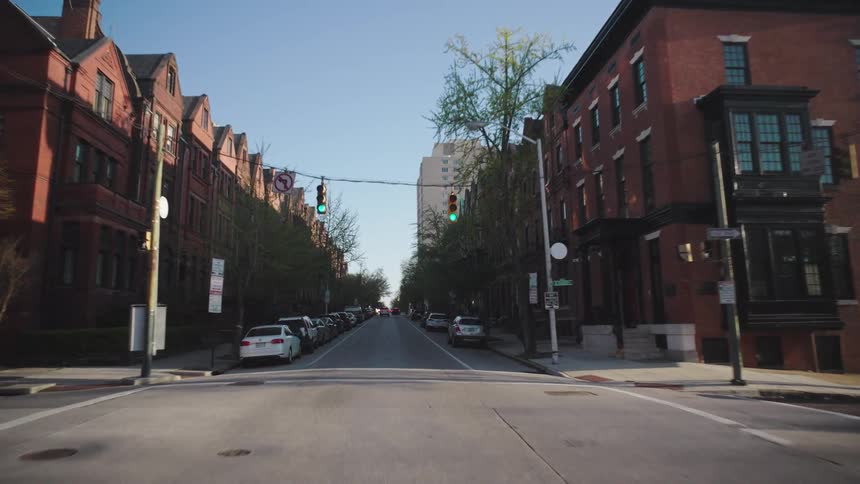 A city street with older brick buildings has no moving traffic