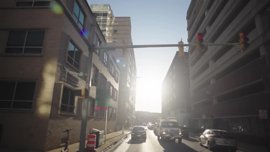 Traffic turns in the intersection by the tall buildings