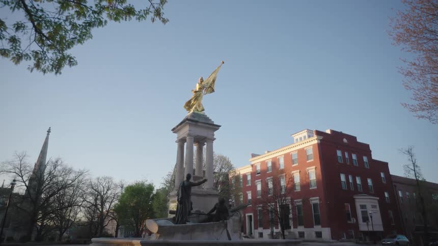 An image of a golden statue in front of a build