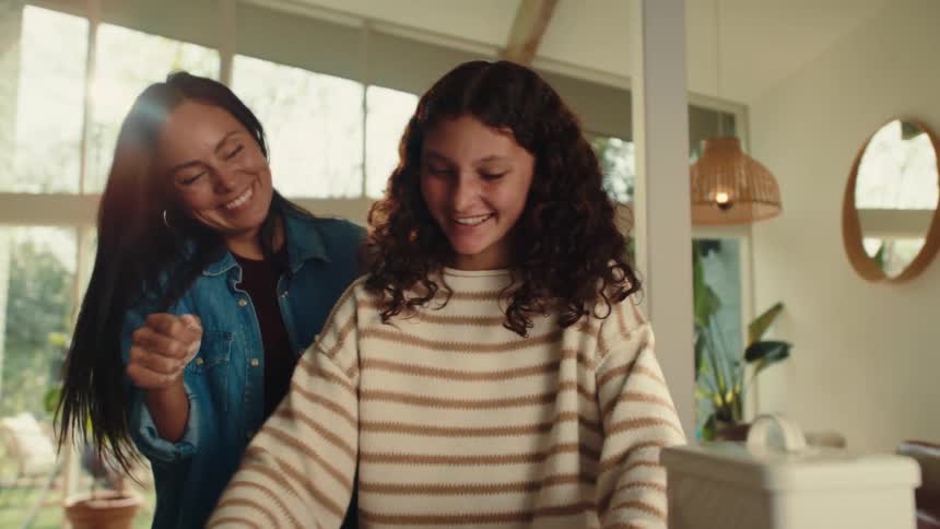 Mother and daughter are having fun prepping the cookie dough for baking