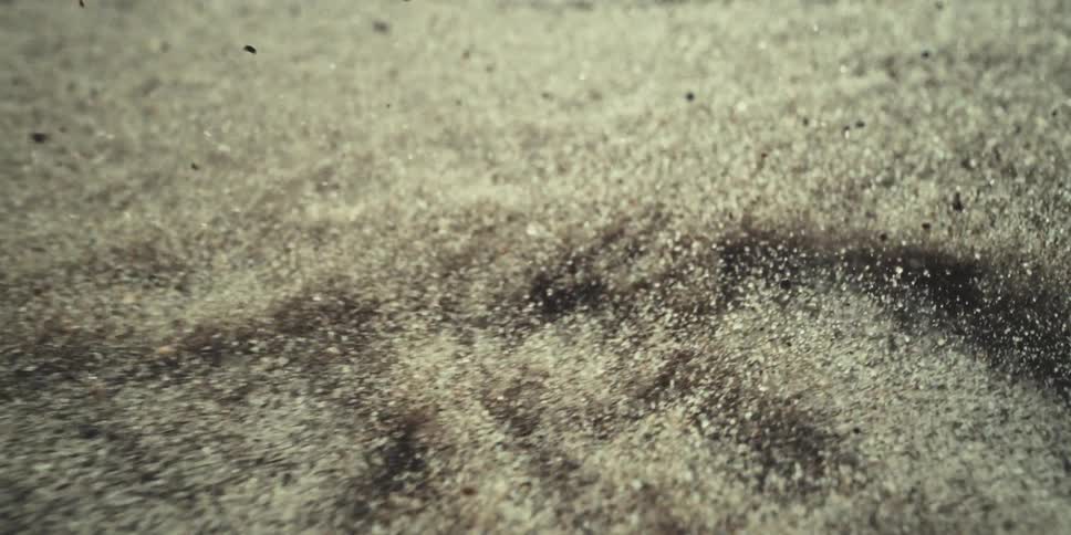 The sand jumps up from the wind