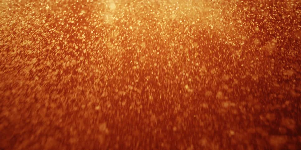 Glowing embers fly through the air in the aftermath of a fiery explosion