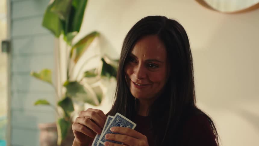 Mother is playing cards with her daughter