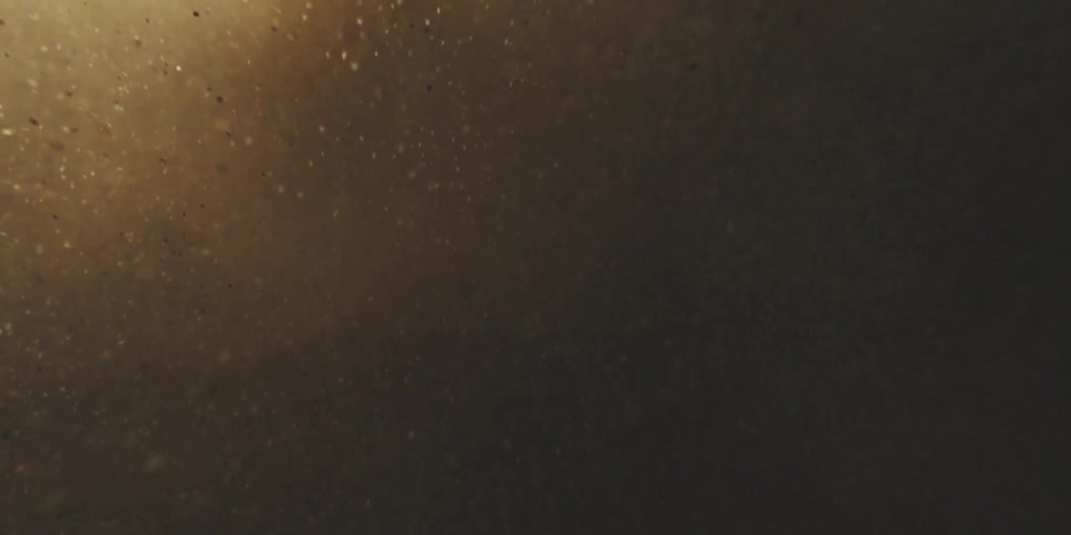 Sand and tiny rocks in the wind in slow motion
