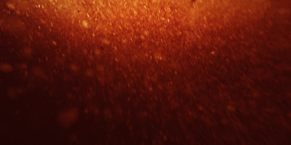A burst of embers and fire envelope the lens inside an explosion