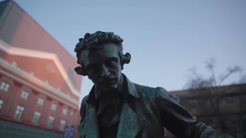 A statue of a man is outside the building