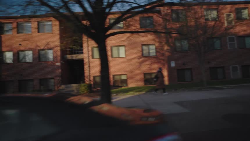 A set of apartment buildings is located on the side of the road