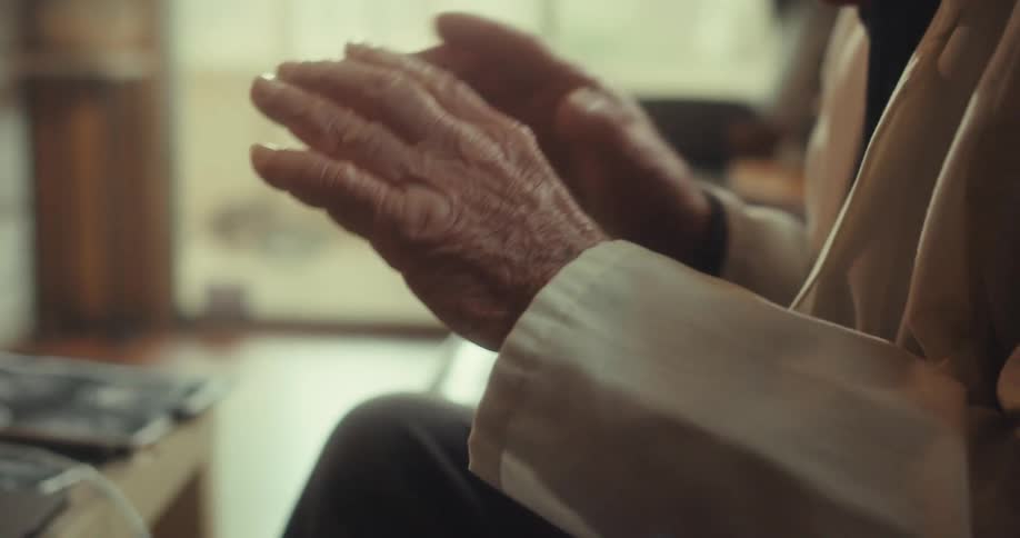 The man points his fingers and talks to the laptop