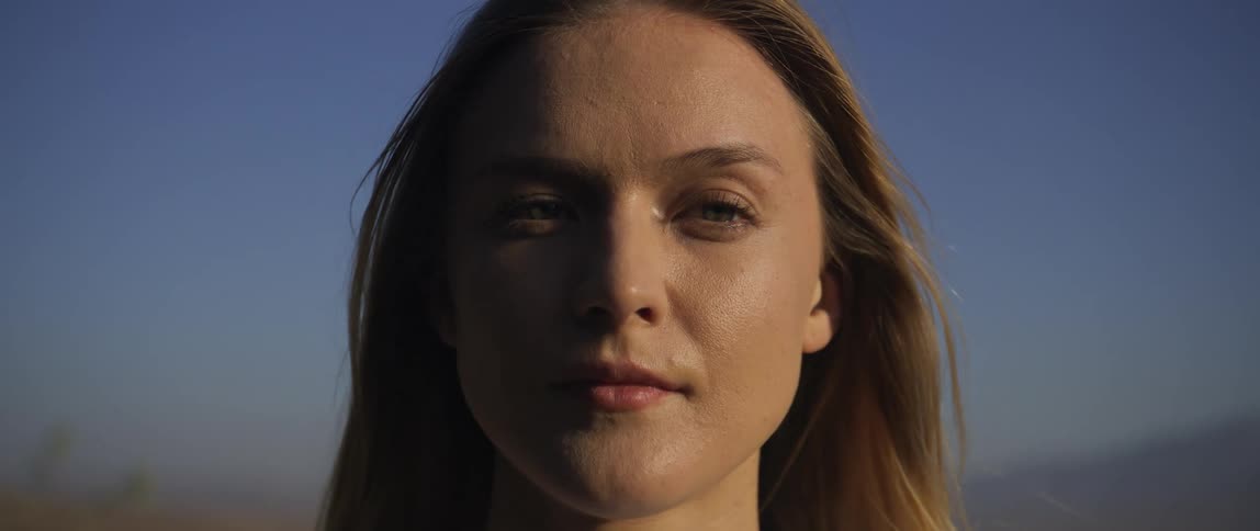 A clear blue sky is above the woman
