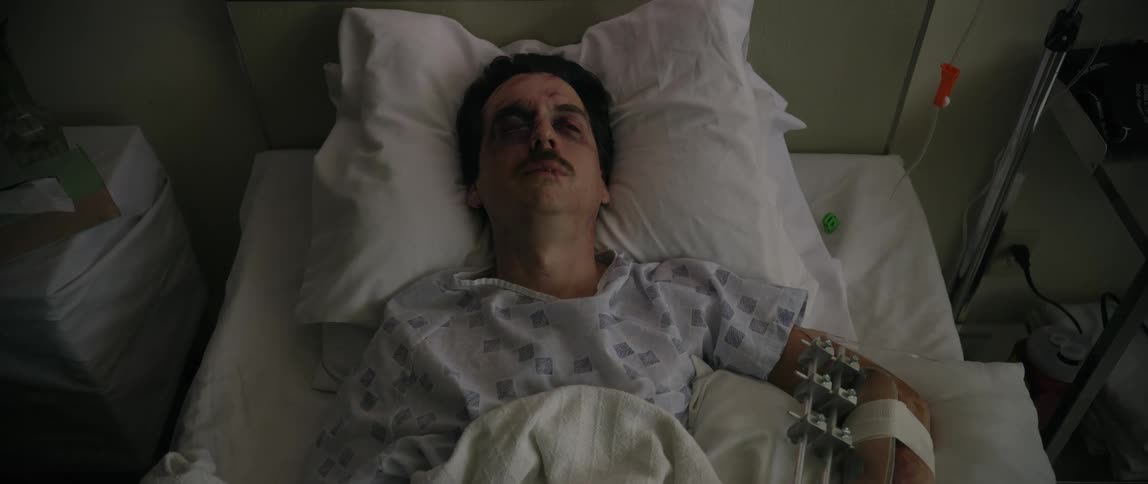 Male patient lying on a hospital stretcher completely weakened