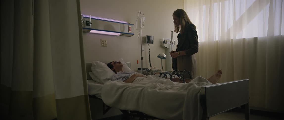 A woman visits a sick man in the hospital