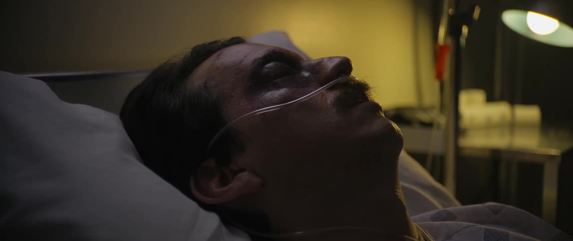 A male patient breathing heavily on the hospital bed at night