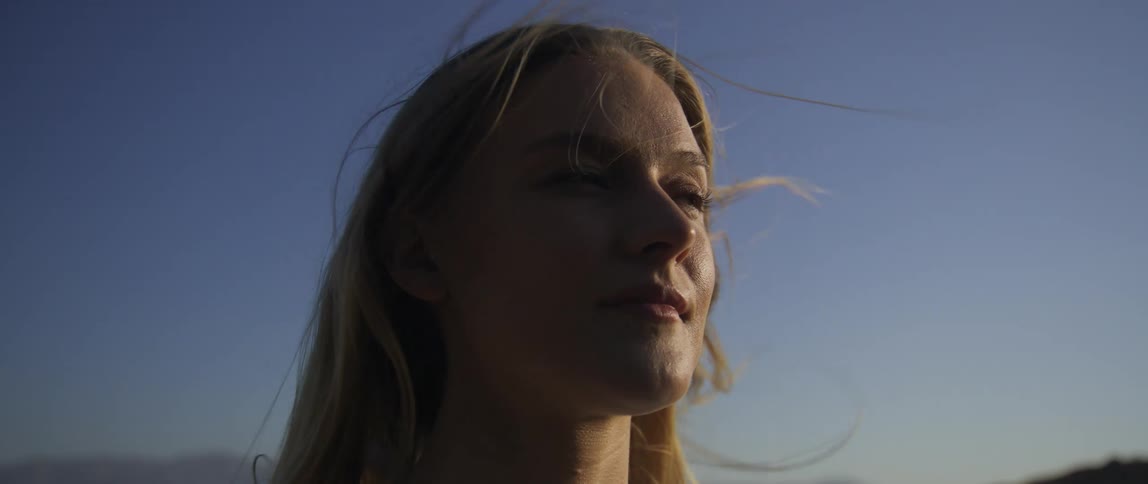 Heavy wind blows the womans hair all over