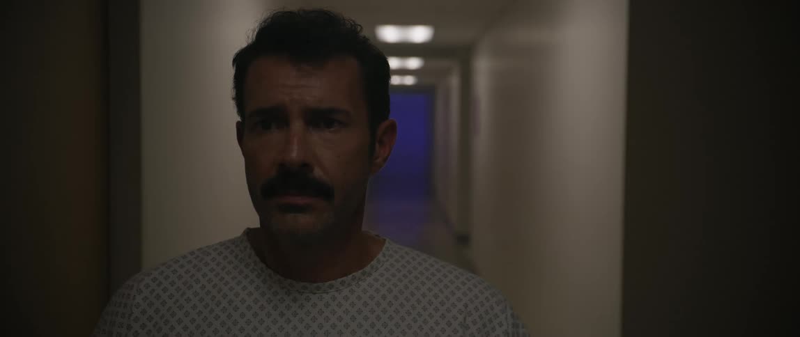 A patient standing in the hospital hallway looking nervous while the lights go out