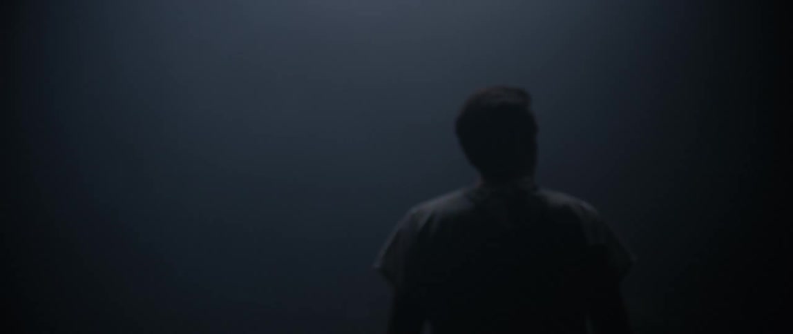 A man is walking in the thick fog