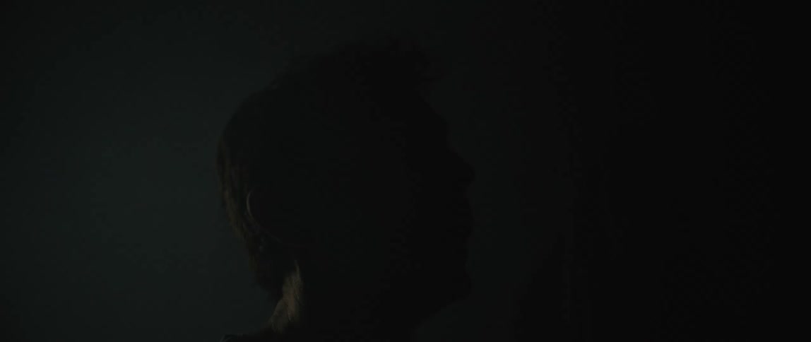 Man in a dark room with flashing lights