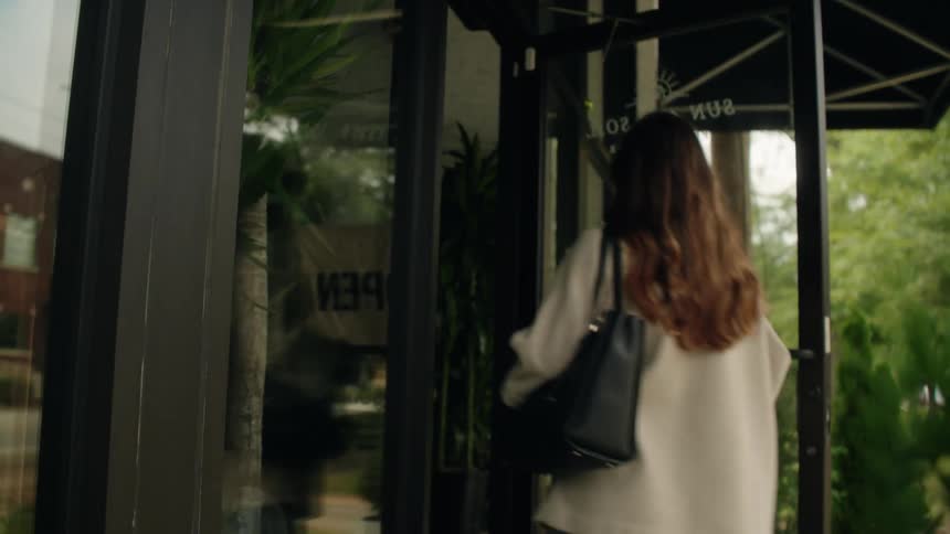 The worker opens the store and turns the sign around at the door
