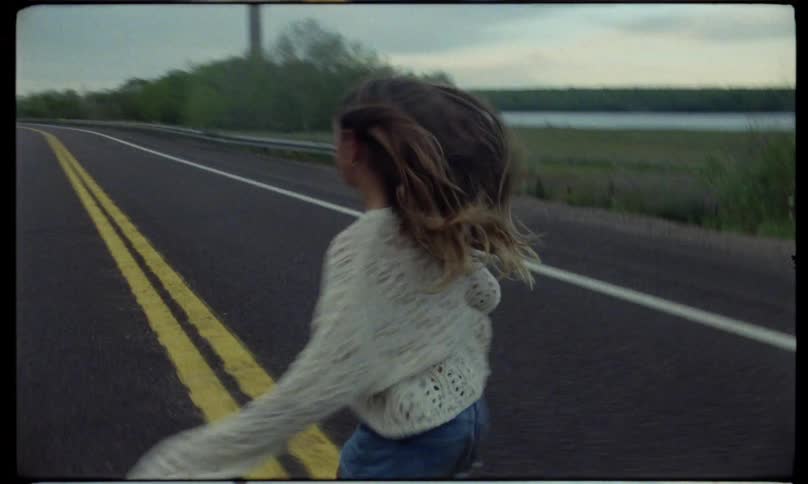 A girl runs across the street