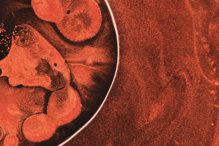 Dense reddish liquid body in abstract movement