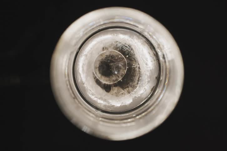 A white circular object with a bubble in the center and it is rotating to the right