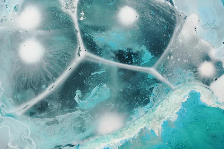 A swirling mix of abstract blue white and black liquid textures flows in an extreme closeup creating a dreamlike visual