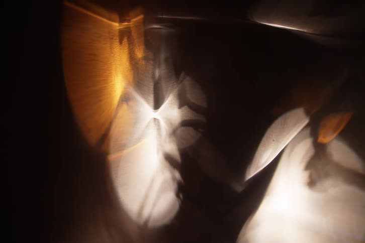 Some white and yellow lights hovering over a dark environment