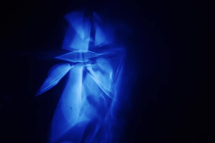 The blue lights shimmer and spin in the dark