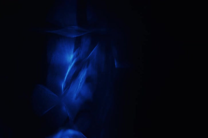 Light display creating dark blue and light blue shapes in a dark room