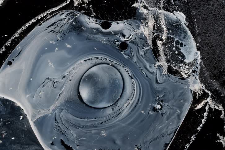 The fluid art spreads and moves