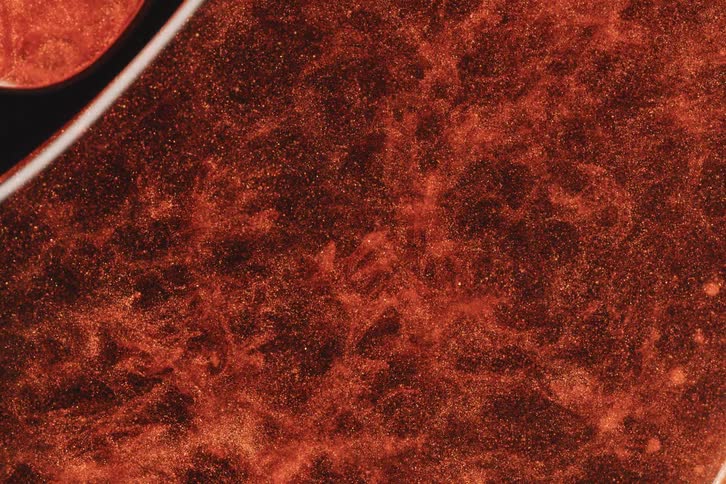 Clouds of red fluid ink move in the artwork