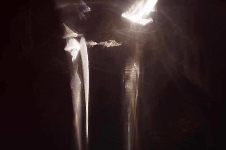 Sunlight shines into shadowed area revealing amorphous shapes